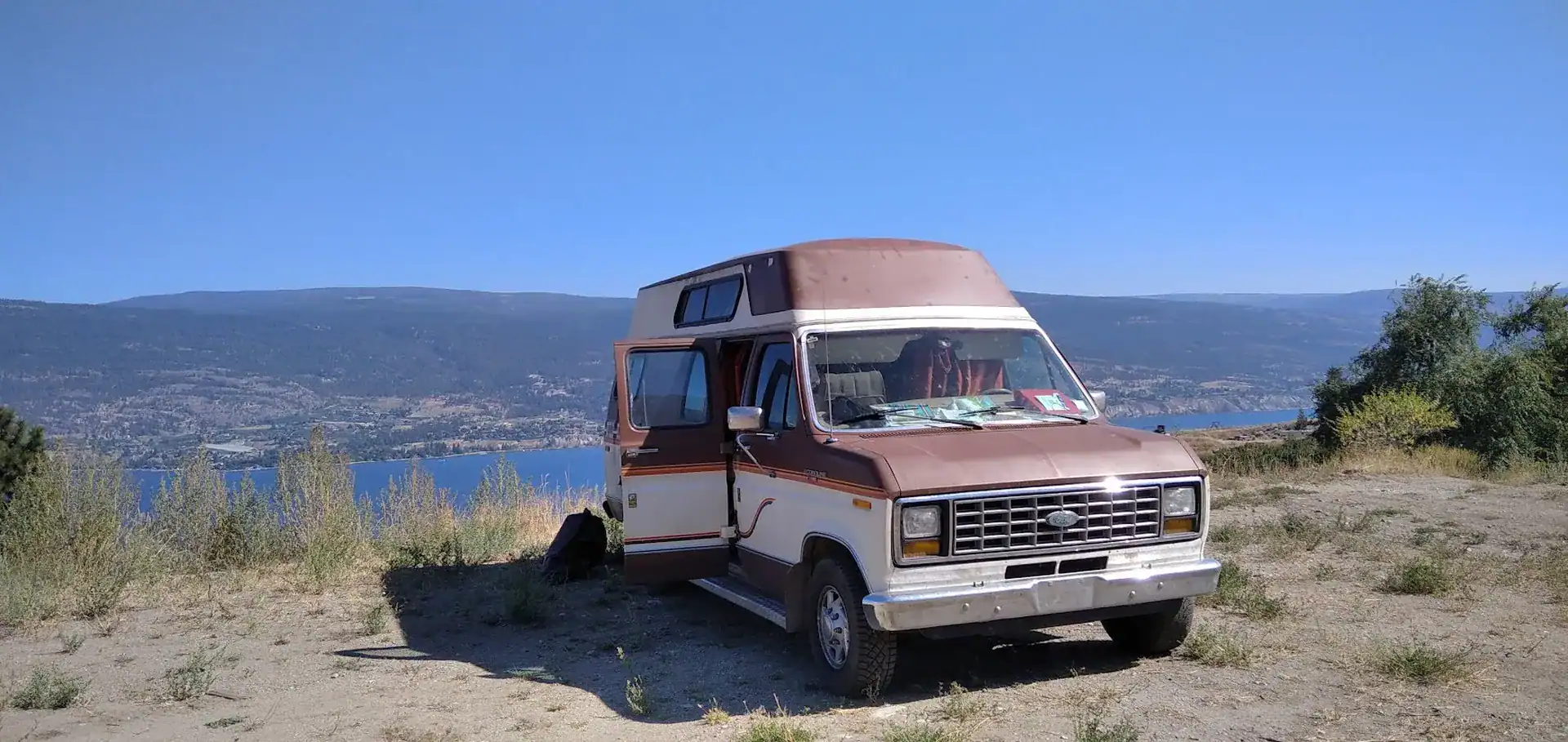 Brown Econoline Ford Van 1985 in a beautiful landscape in Canada