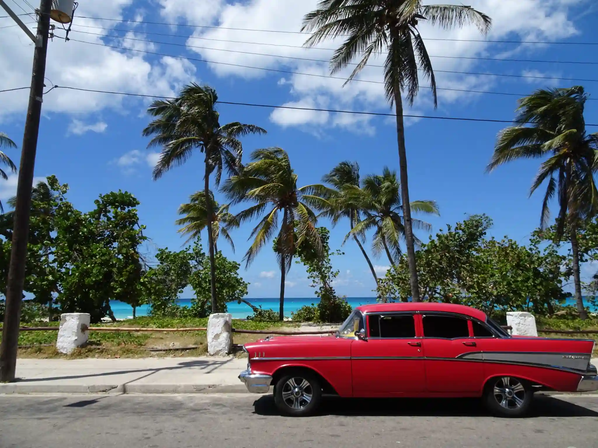 Cuba, travel cuba, a old-timer car by a beautiful blue water beach