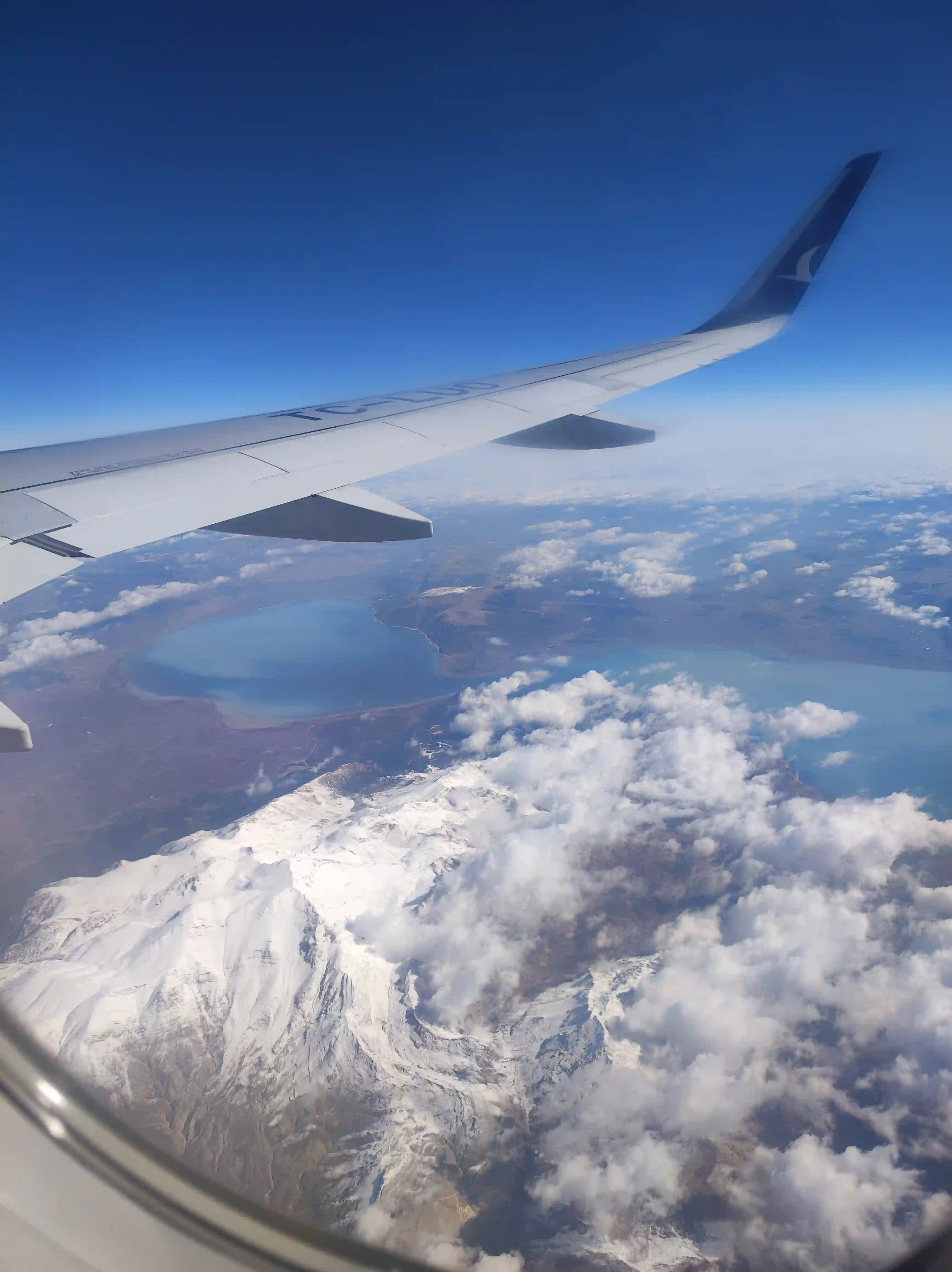 Travel essentials view on mountains from a plane